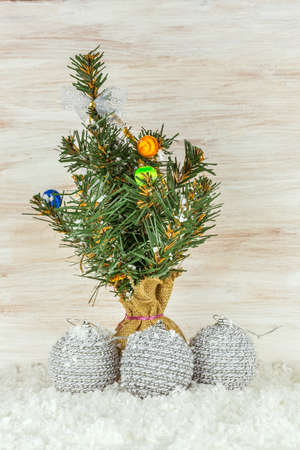 Christmas balls with fir branches and snowflake on wooden backgroundの写真素材