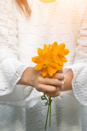 Flower girls holding hands and gave you.の写真素材