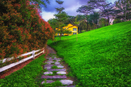 European style house, lawn, trees, flowers and mountain views.の写真素材