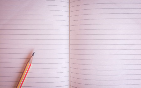 Pencil and wooden color on an empty book on the table