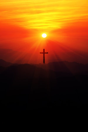 Silhouette of christian cross on the mountain at sunset.の写真素材