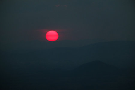 Beautiful sunset in the mountains. The sun sets behind the mountains.の写真素材