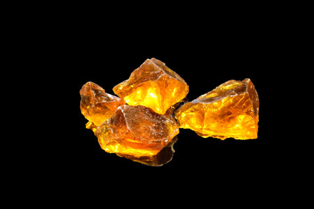 Amber on a black background with reflection. Natural amber on a black background.の写真素材