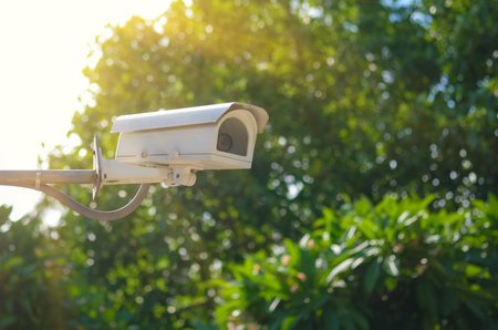 CCTV security camera or surveillance camera on green nature background with copy space.の写真素材