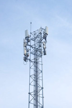 Telecommunication tower with blue sky background, telecommunication technology concept.