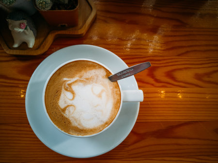 Hot coffee in a white cup on a wooden table