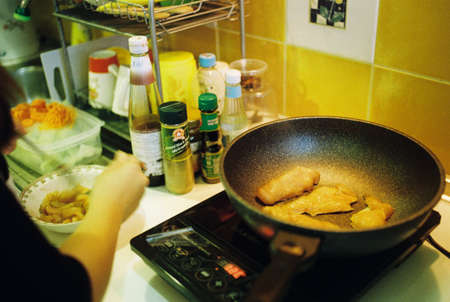 Bangkok/Thailand-05192017: Young women cooking in the kitchen on condominiumsのeditorial素材
