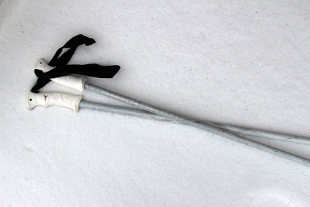 Ski poles lying in the snow (horizontal)