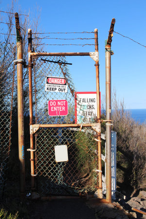 Do not enter sign on the closed entrance to the danger zone on the edge of a cliff. Oahu, Hawaii