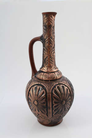 Vintage clay bottle of red wine on a white backgroundの写真素材