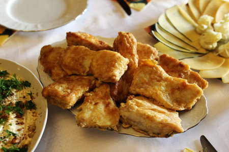 Home-style fried fish fillets on the table served for a partyの写真素材