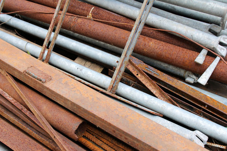 A pile of rusty iron pipes and other metal scrapの写真素材