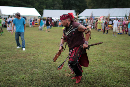 A native American performer dressed in a traditional costume dancing at the Annual Indian Tribe Fall...