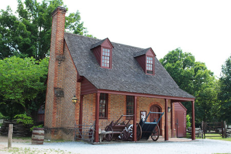 American colonial architecture: a brick farmhouse with an open storage shed