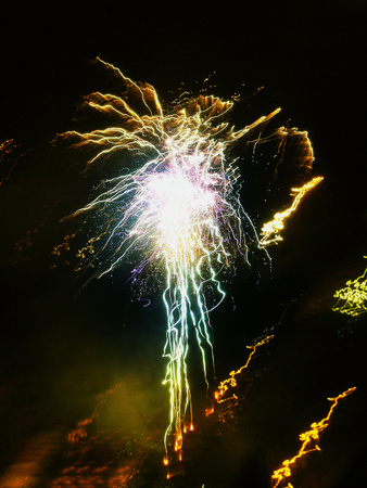 Firework with green and yellow raysの写真素材
