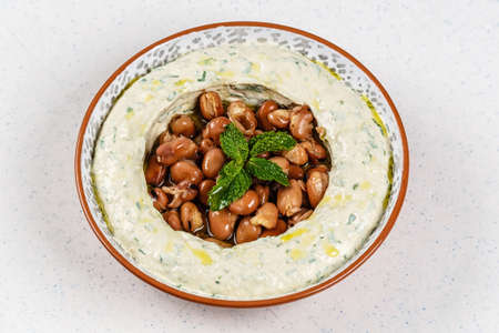 arabic food Hummus with parsley in a traditional bowl and nutsの写真素材