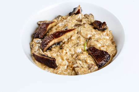risotto with truffles served in the white plate on the black backgroundの写真素材