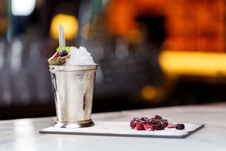 Cold cocktail with passion fruit on stone background.の写真素材