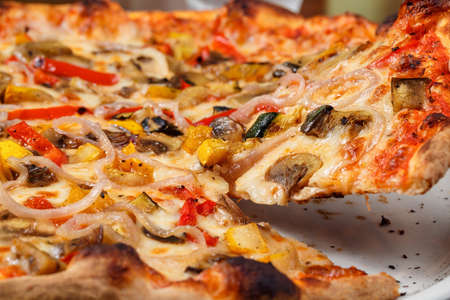 Supreme pizza lifted sliceの写真素材