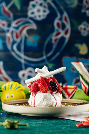 Ann Pavlova dessert with berries and bright backgroundの写真素材