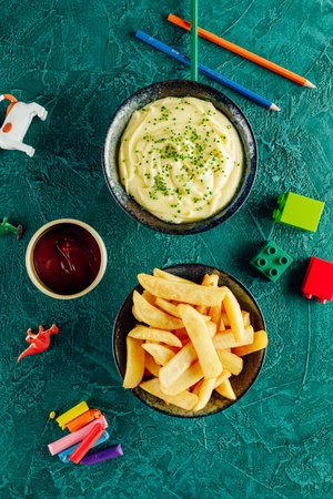 French fries and mashed potato with ketchup and props