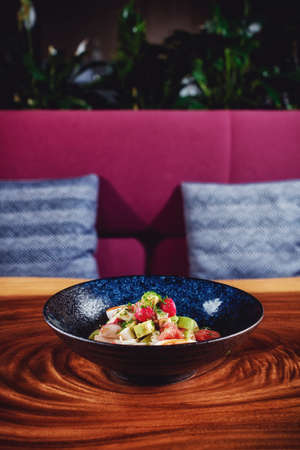 Vegetable salad with boiled eggs mixed with sour cream, parsley and green onion. Placed on the wooden background の写真素材