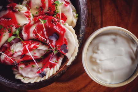 Dumplings with cherries served with the jam and sour cream