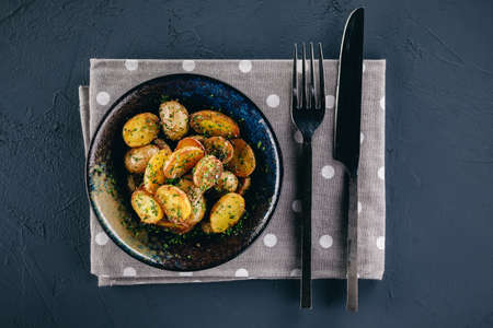 Pan fried cherry potatoes with garlic and onionの写真素材