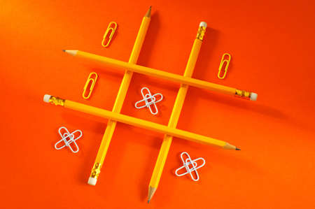 logic game (pencil and paper clip on a dark red background)の写真素材