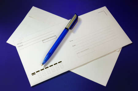 Envelope and pen (on a dark blue background) の写真素材