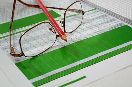 Glasses and red pencilの写真素材