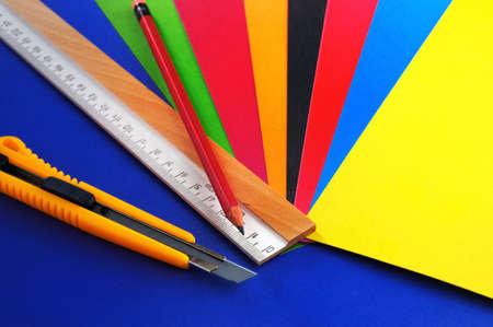 School office suppliesCutter , ruler , pencil and a multi-coloured cardboard の写真素材
