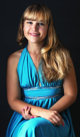 Portrait of the young girl on a dark grey backgroundの写真素材