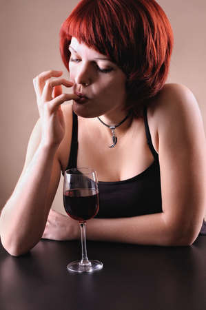 girl c a red wine glass on a dark grey backgroundの写真素材