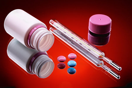 Medicinal preparations on a dark red background