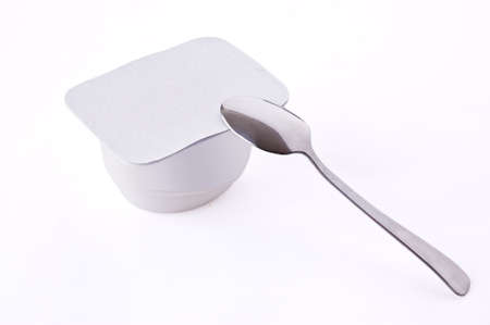 Tea spoon with yoghurt on a light backgroundの写真素材