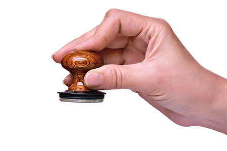 Hand with stamp for documents on white backgroundの写真素材