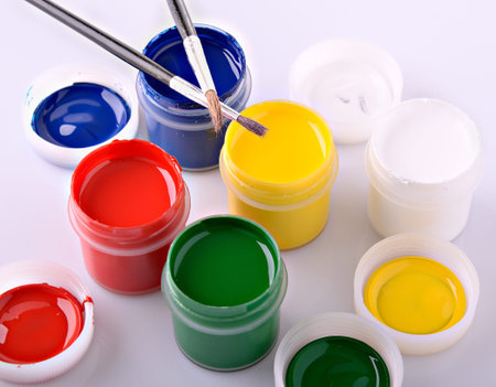 colored acrylic paint containers and paint brushes