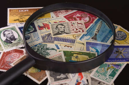 lens is located on a group of old postage stampsの写真素材