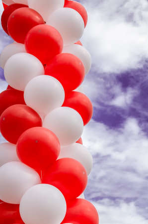 bunch of colorful balloons on a background cloudy skyの写真素材