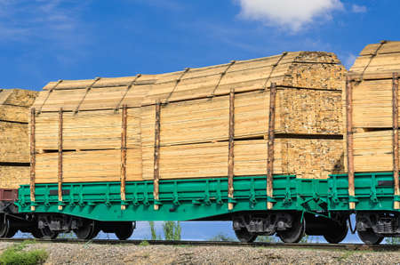 wagon laden with boards on the background blue skyの写真素材