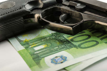 gun and money on a white backgroundの写真素材