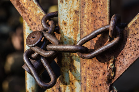 old padlock on metal gateの写真素材