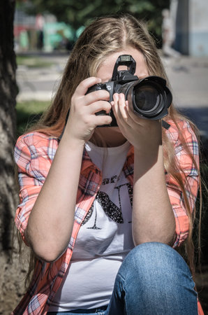 Portrait of a young teen girl with camera