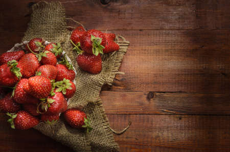 ripe berry on a dark wooden background in a rustic styleの写真素材