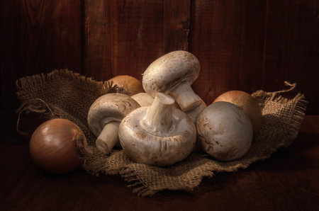 mushrooms on a burlap napkin on a dark wooden background in a rustic style