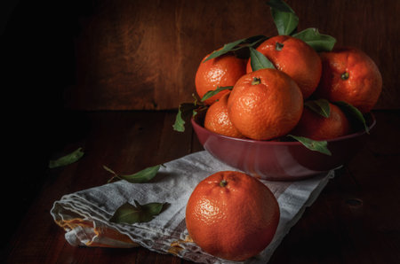 tangerines in bulk on a coarse fabric, in a dark rustic style