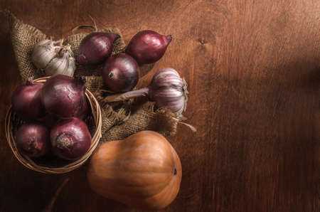 Vegetables on a dark wooden background in a rustic styleの写真素材