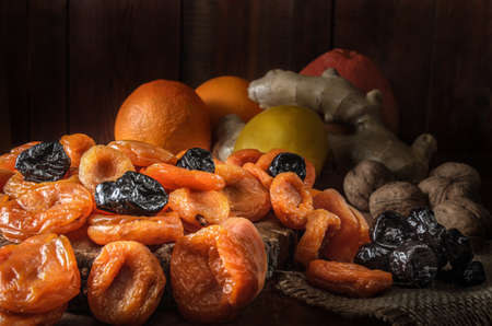 dried apricots and other dried fruits on a dark wooden backgroundの写真素材