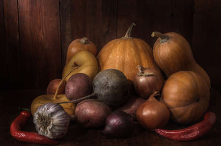 Vegetables on a dark wooden background in a rustic styleの写真素材